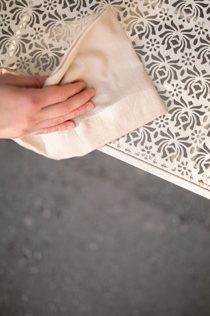 Young woman disinfecting before opening