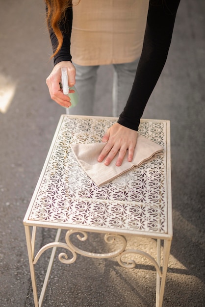 Free photo young woman disinfecting before opening