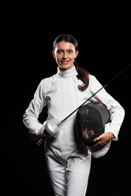 Free photo young woman doing fencing