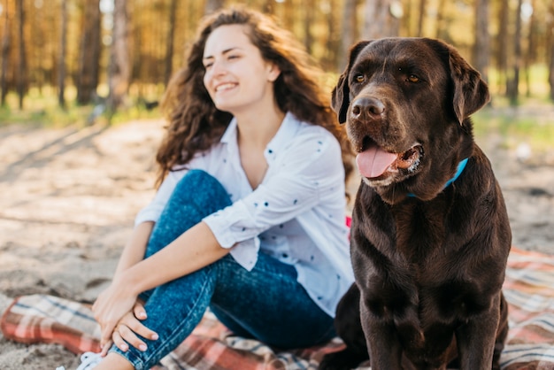 Young woman doing a picnic with her dog