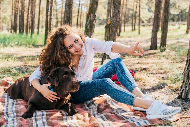 Young woman doing a picnic with her dog