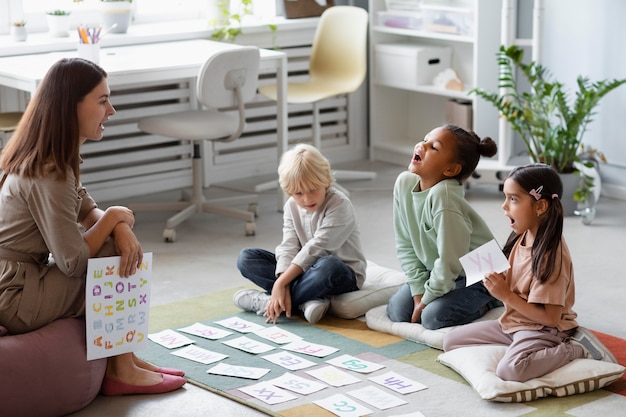 Free Photo young woman doing speech therapy with kids