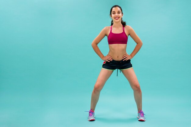 Young woman doing squats