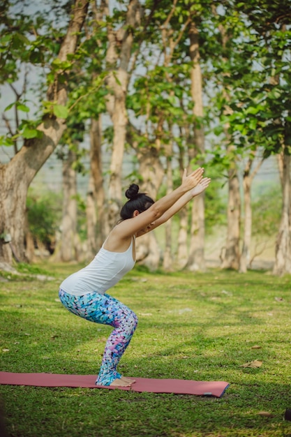 Young woman doing yoga in a sunny day