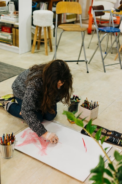 Free Photo young woman drawing on floor