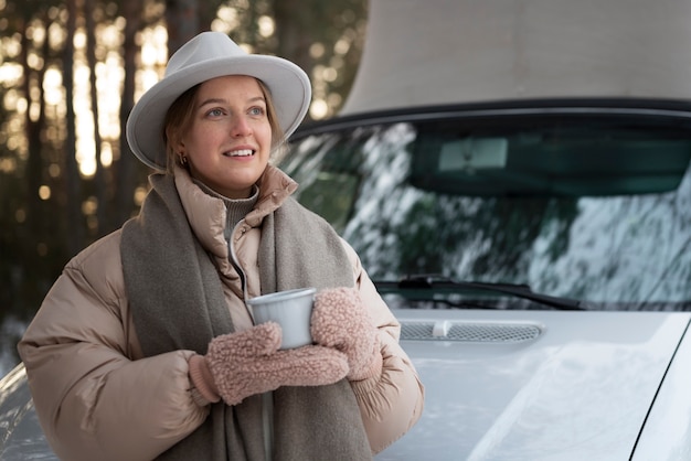 Free photo young woman drinking hot beverage