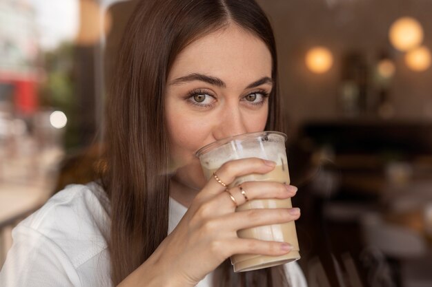 Young woman drinking iced coffee