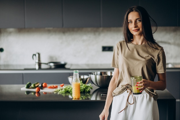 Free Photo young woman drinking juice at home