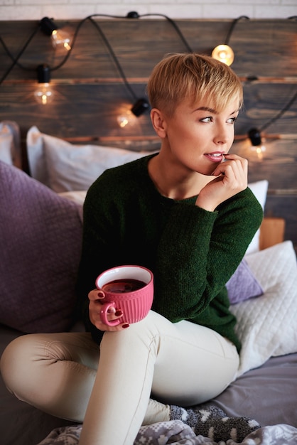 Young woman drinking tea in winter day