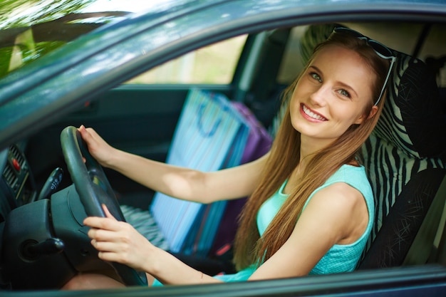 Free photo young woman driving her car