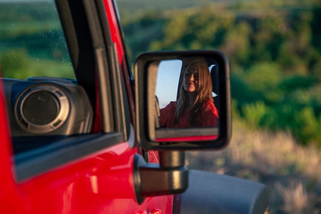 A young woman driving an suv in the countryside