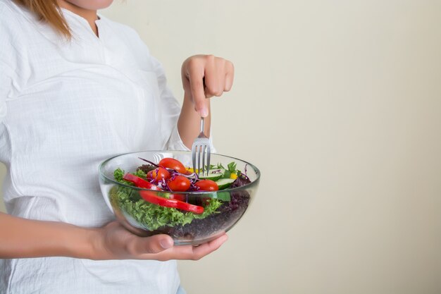 Young woman eating healthy salad