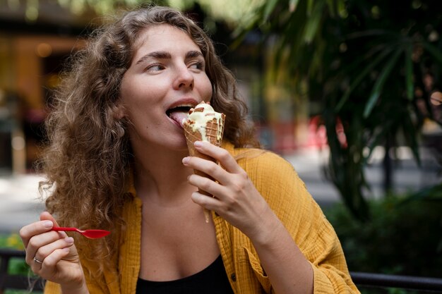 Young woman eating ice cream cone