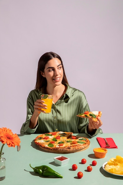 Free photo young woman enjoying a delicious pizza