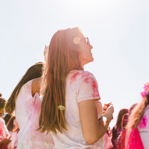 Free photo young woman enjoying the holi festival with her friend