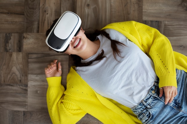 Free photo young woman enjoying new technology vr glasses