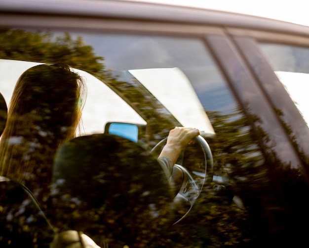 Free photo young woman enjoying road trip