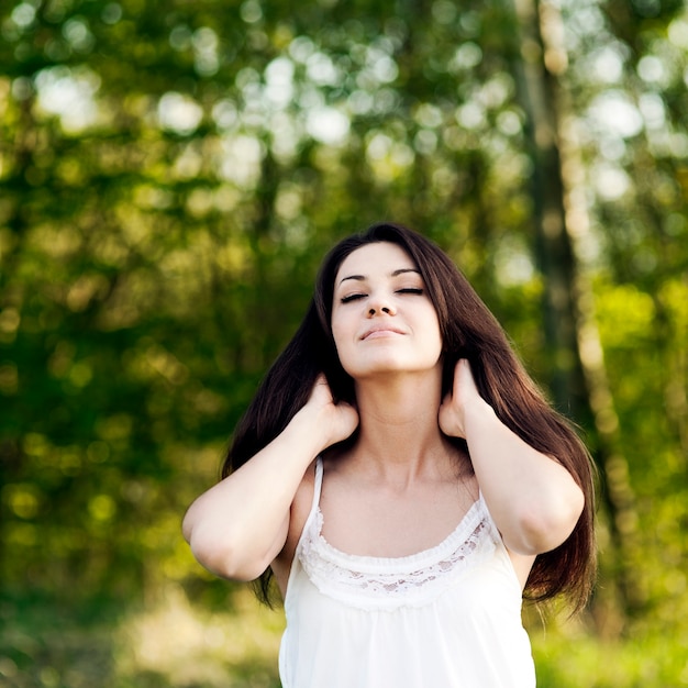 young woman enjoying the summer in a park