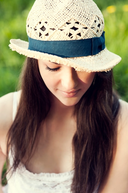 Free photo young woman enjoying the summer in a park