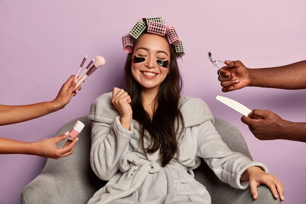 Young woman enjoys beauty spa at home siting in bathrobe