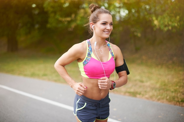 Free photo young woman exercising outdoor. summer helps in getting motivation