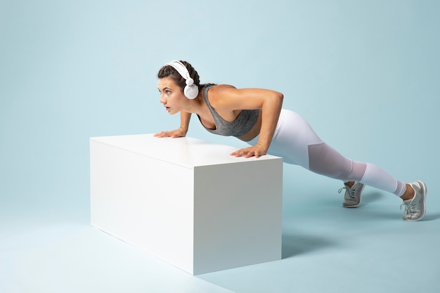 Young woman exercising with her headphones on