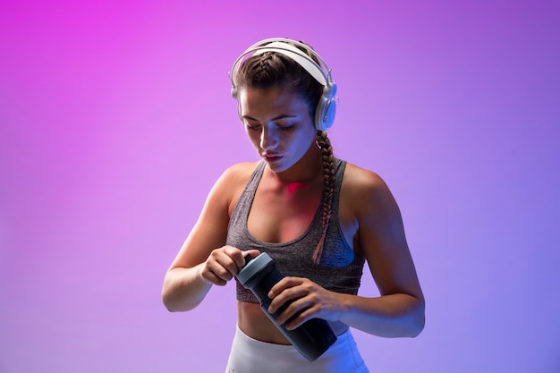 Young woman exercising with her headphones on