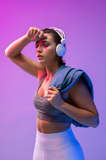 Young woman exercising with her headphones on