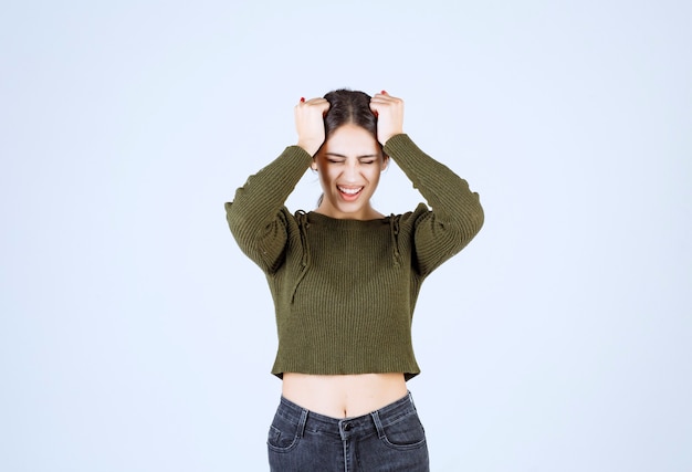 Free photo young woman feeling angry and screaming on white background.