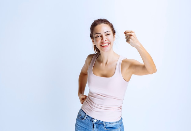 Free photo young woman feels happy and showing positive hand signs