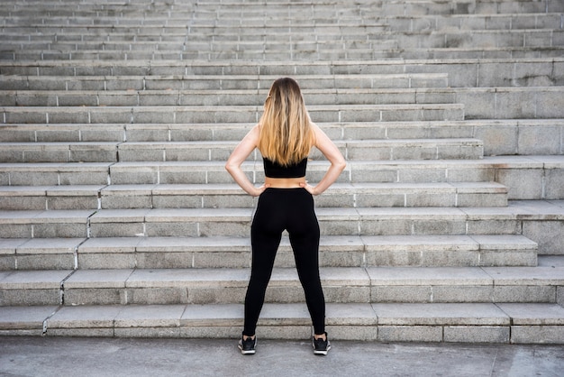 Young woman in front of stairs