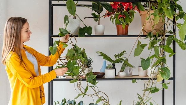 Free photo young woman gardening at home