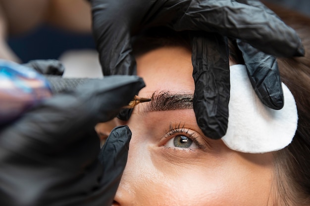 Young woman getting a beauty treatment for her eyebrows