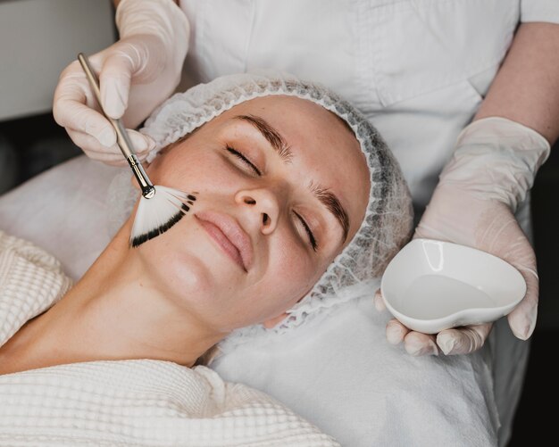 Young woman getting a face skin treatment