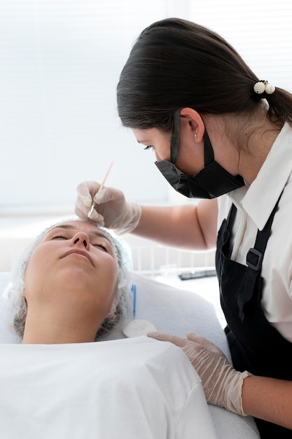 Young woman going through a microblading procedure