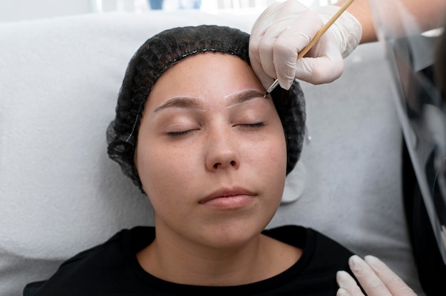 Young woman going through a microblading procedure