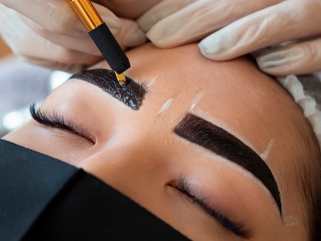 Young woman going through a microblading procedure