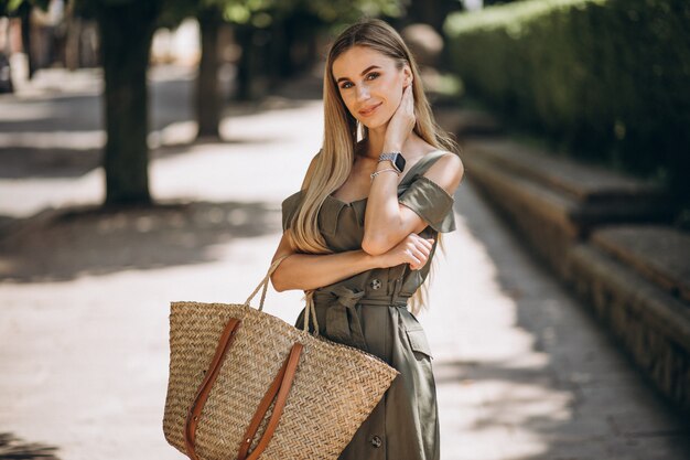 Young woman in green dress outside in park