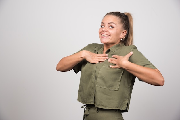 Young woman in green jacket feeling happy.