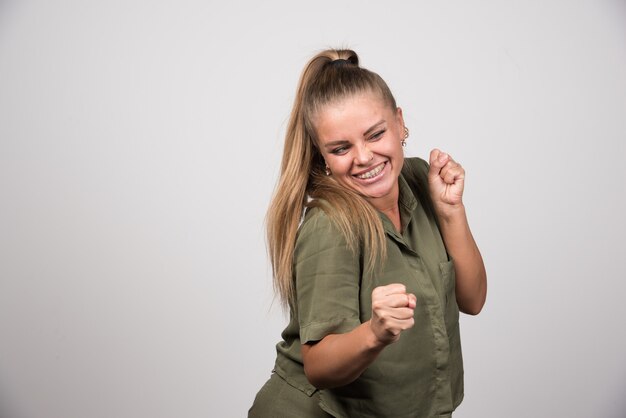 Free Photo young woman in green outfit feeling happy.