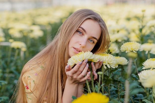 Young woman in a greenhouse with flowers