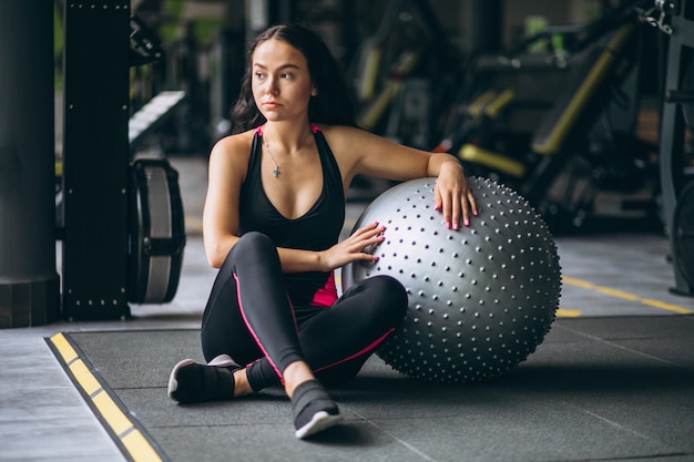 Free photo young woman at the gym exercing with equipment