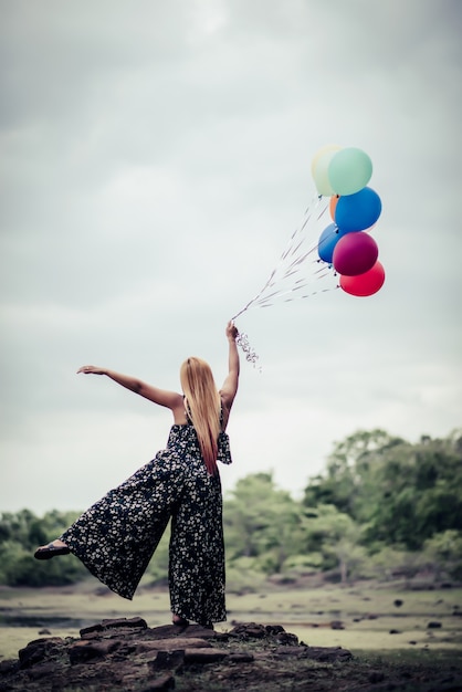 Free photo young woman hand holding colorful balloons