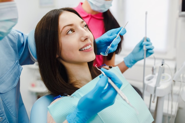 Free photo young woman having a dental treatment at clinic