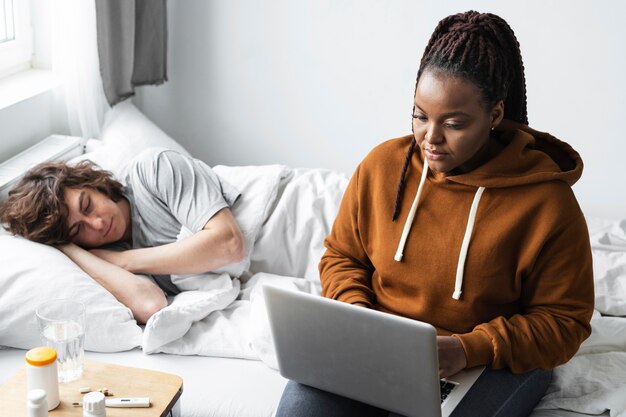 Young woman having a video call with a doctor for her friend