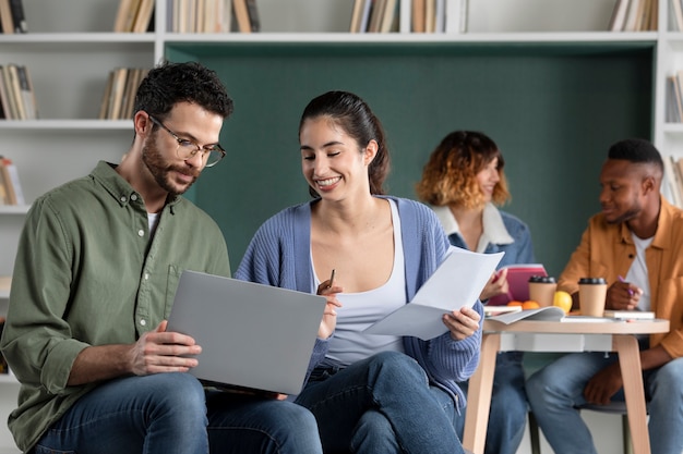 Free photo young woman helping her friend during study session