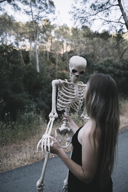 Free photo young woman holding bones