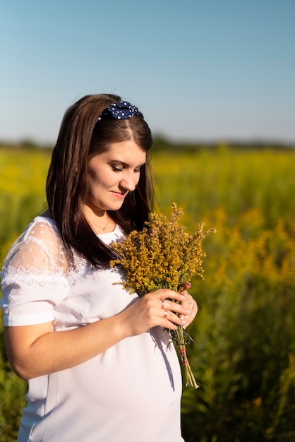 Young woman holding a bouquet in nature