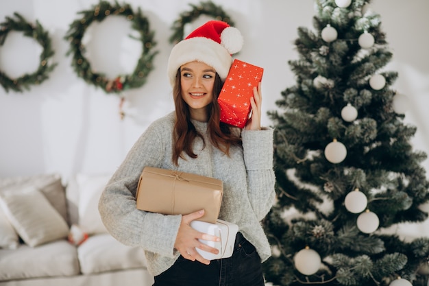 Young woman holding christmas presents