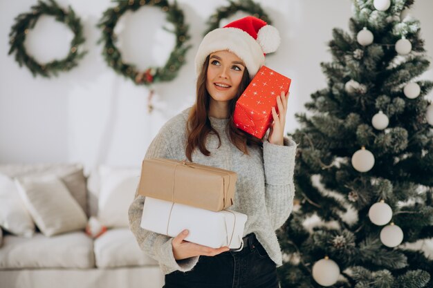 Young woman holding christmas presents